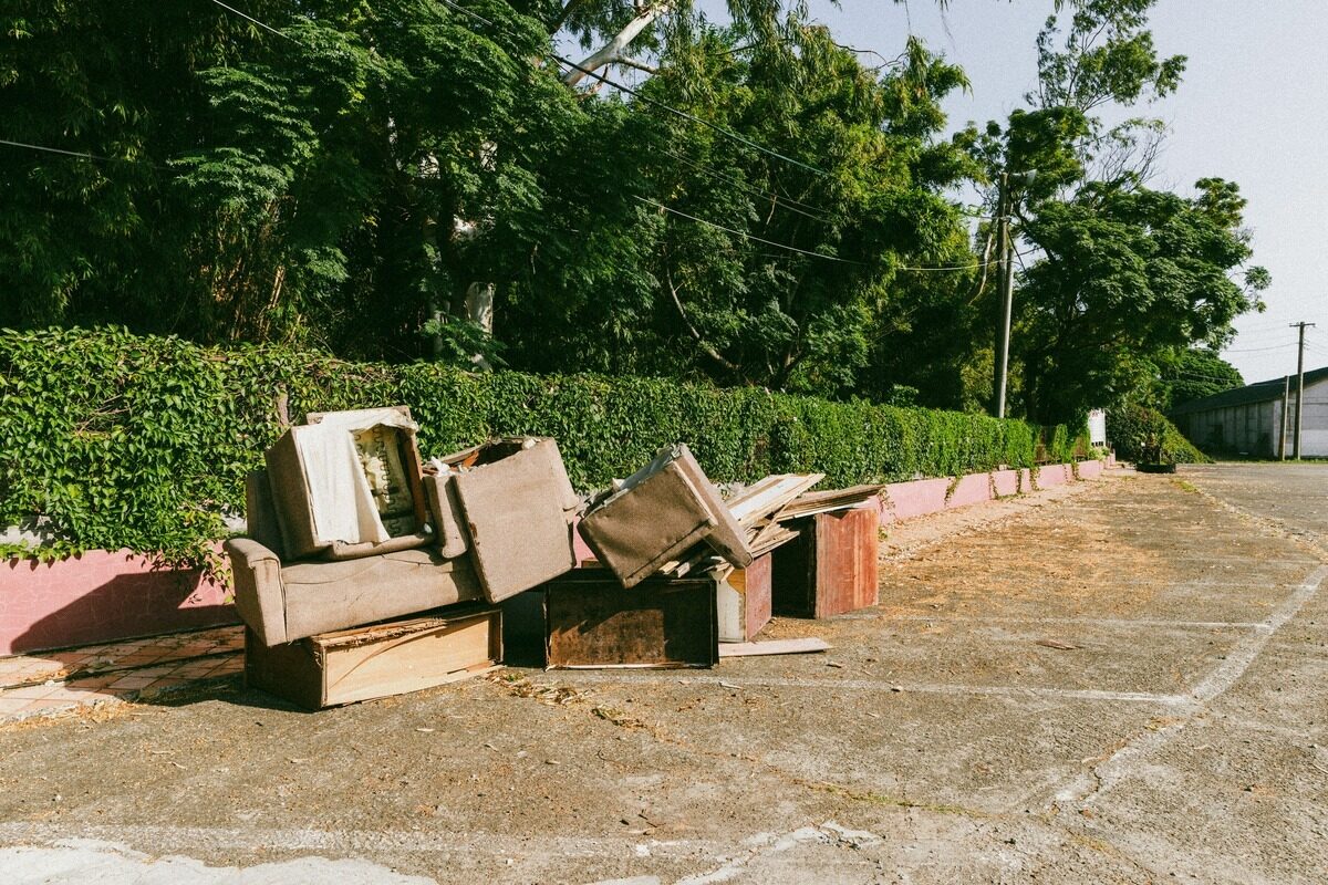 Worn sofa and dresser left out for pickup